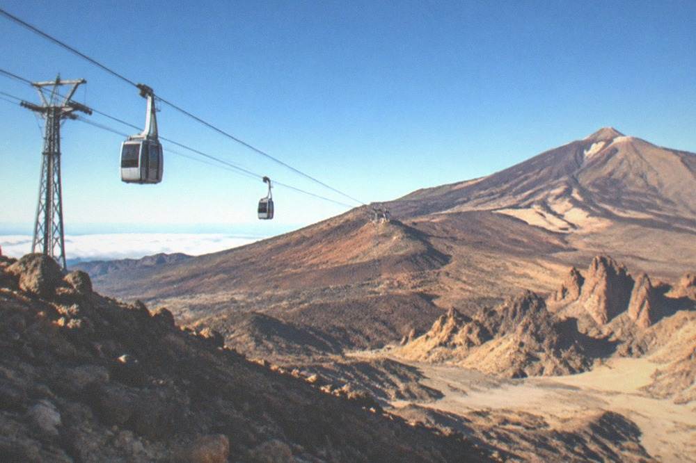 Cable car cabins travelling over volcanic slopes towards the upper station on Teide
