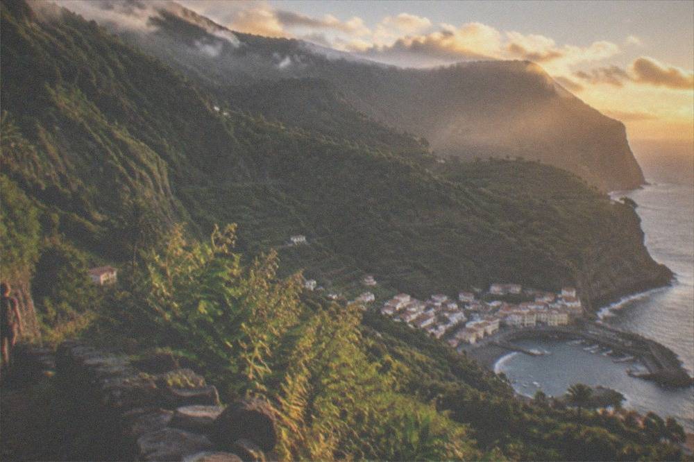 A green forested valley on La Gomera with mist over the ridges
