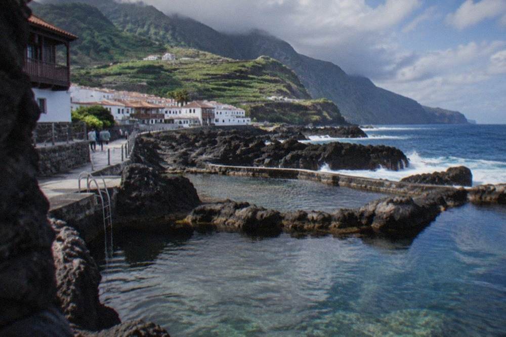 Volcanic rock pools filled with clear sea water along the Tenerife coast