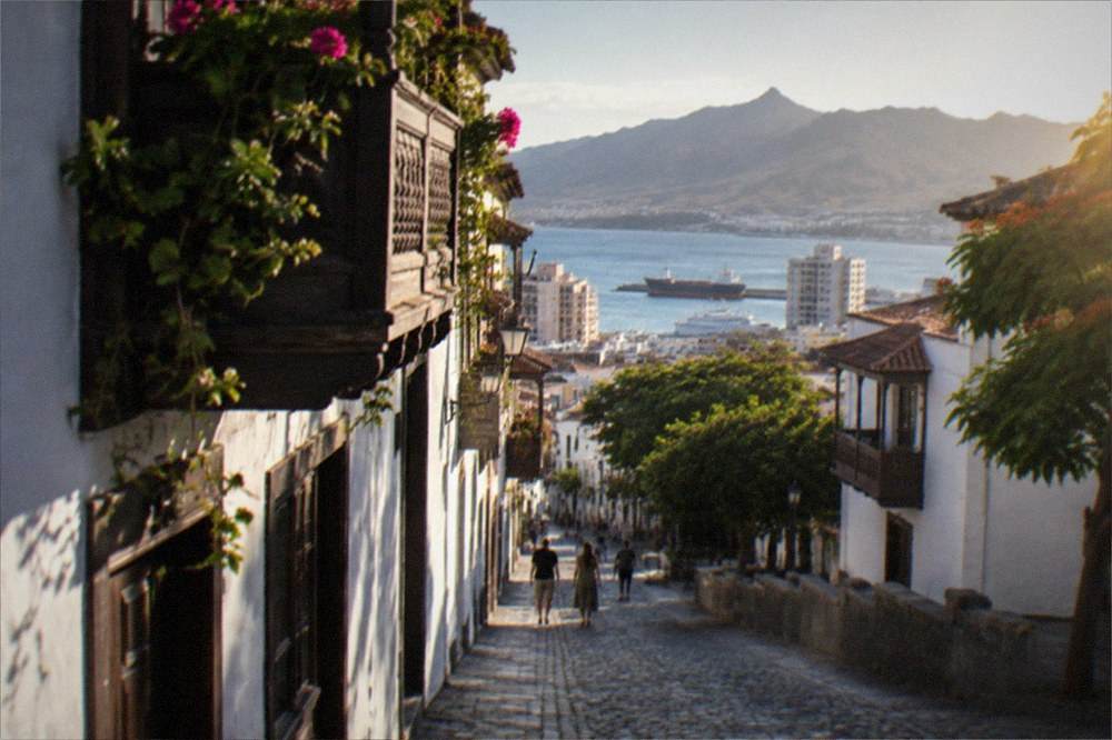 A cobbled colonial street with white balconied buildings in a northern Tenerife town