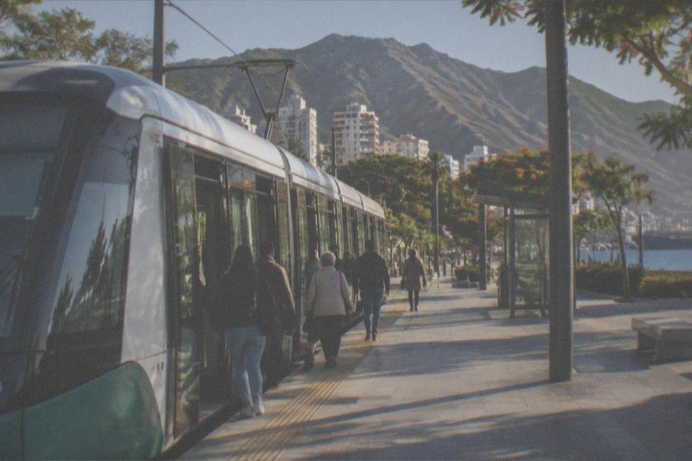 A tram at a stop in Santa Cruz de Tenerife with passengers boarding
