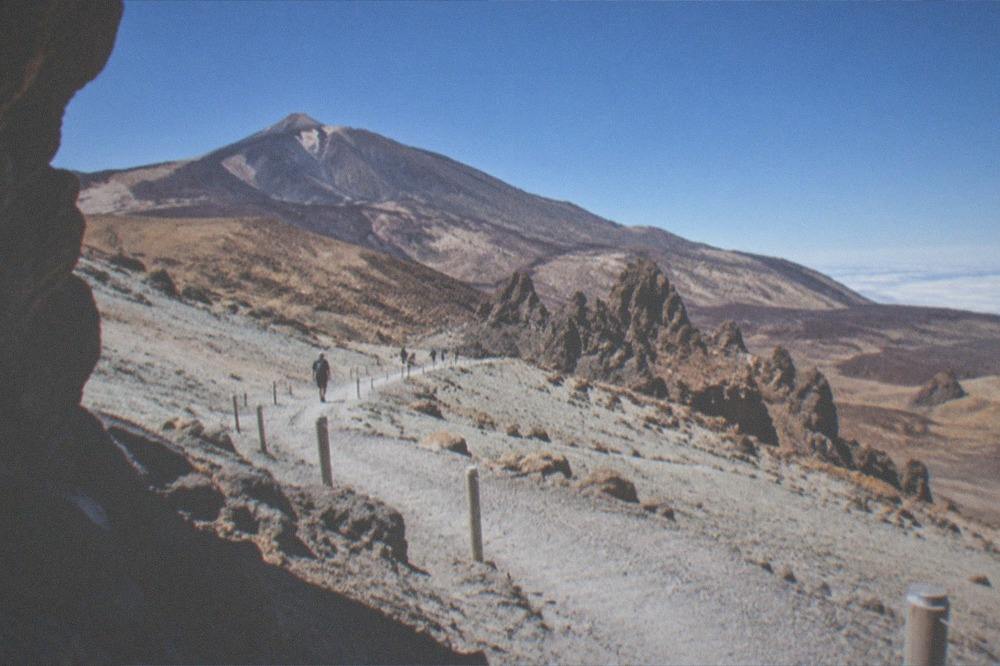 The Montana Blanca trail crossing pale volcanic ash with a line of small marker posts