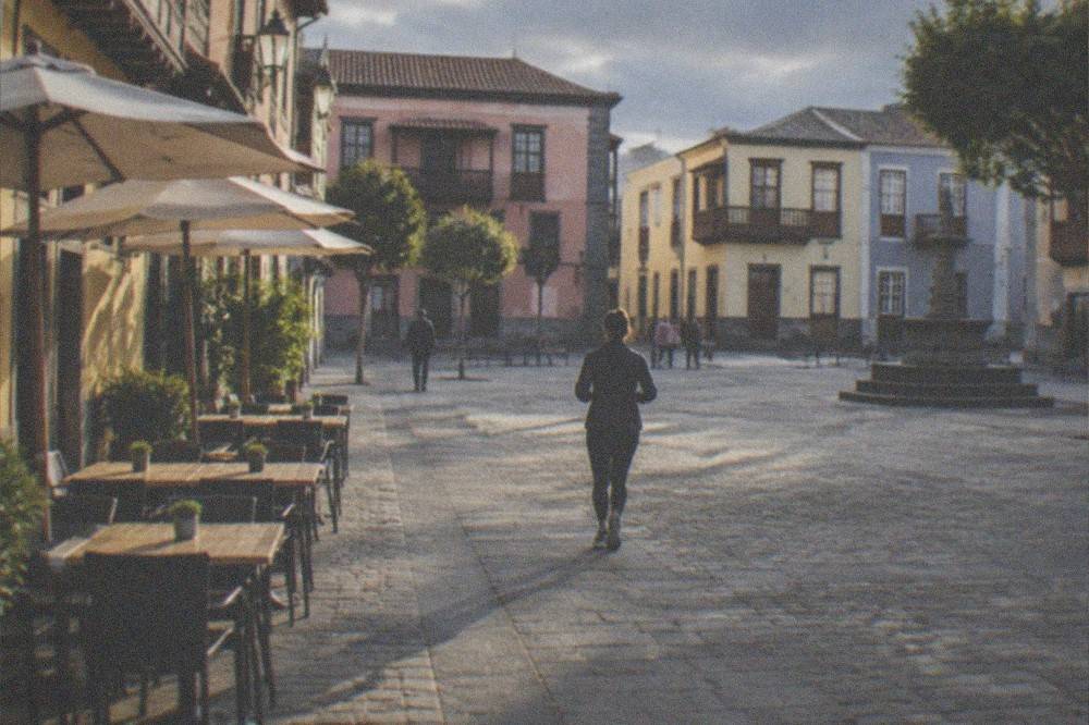 A village square in northern Tenerife with tables set outside a small restaurant