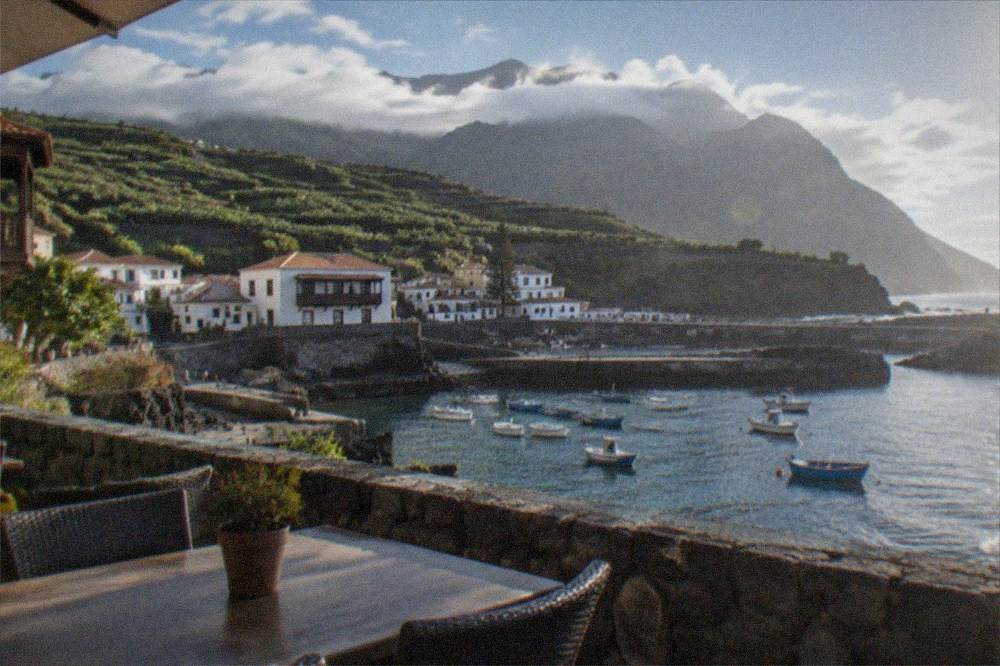 A restaurant terrace in Garachico overlooking the small harbour at midday