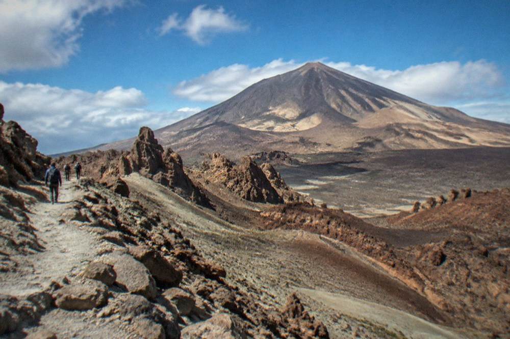 A rocky volcanic trail on Mount Teide under a wide sky