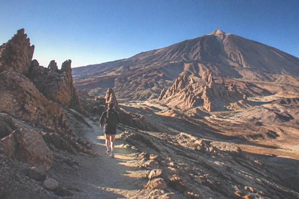 Volcanic rock formations in Teide National Park under a deep blue sky