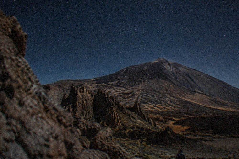 A clear evening sky full of stars above the volcanic slopes of Teide National Park