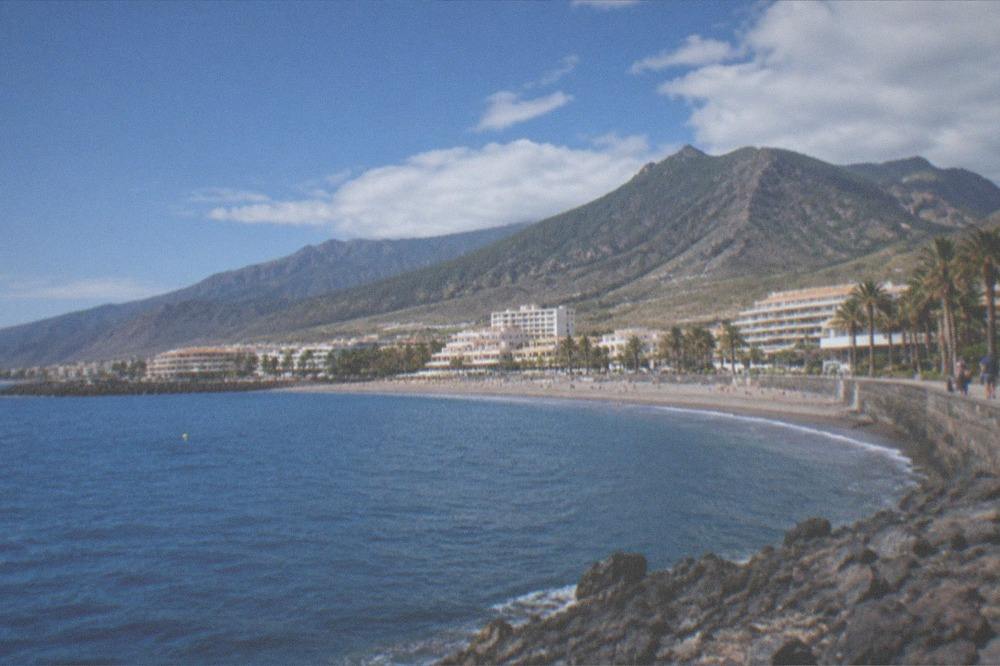 Green forested mountains in northern Tenerife under a partly cloudy sky