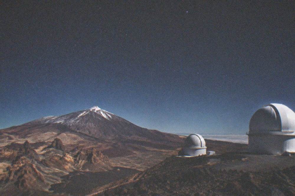 White telescope domes of the Teide Observatory on a clear winter day