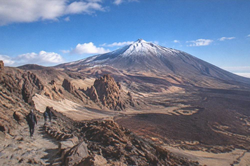 The Teide summit cone dusted with snow under a clear blue sky