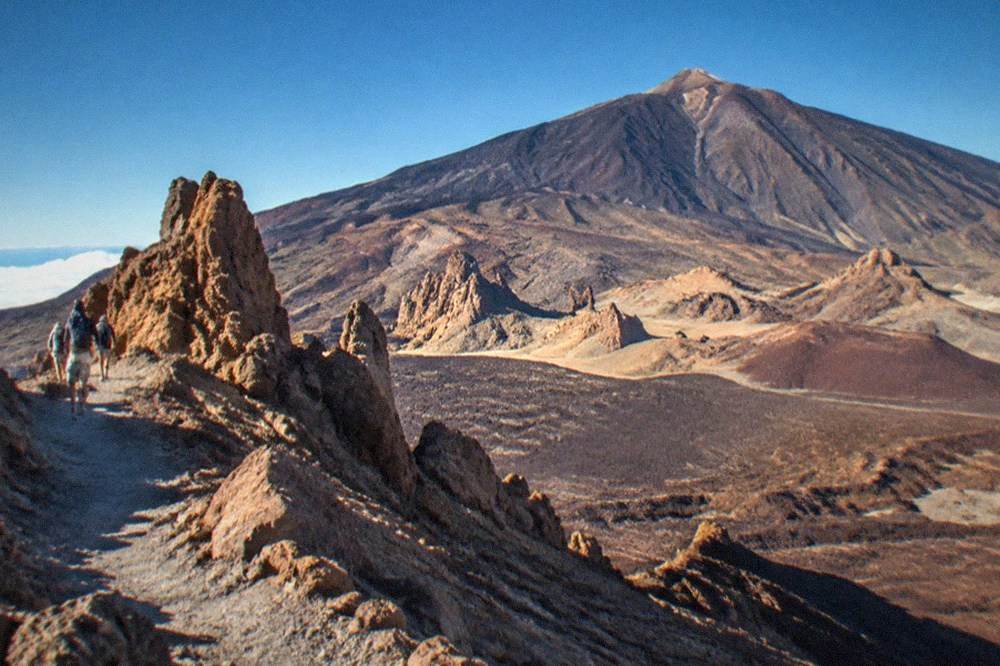 High volcanic slopes of Teide National Park under a deep blue summer sky