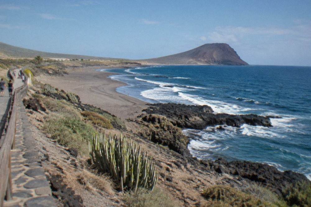 A coastal promenade in south Tenerife under a clear blue June sky