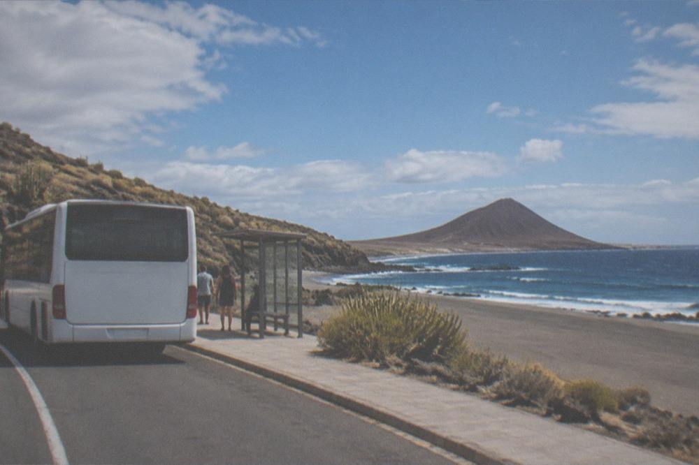 A Tenerife bus at a stop under bright summer light