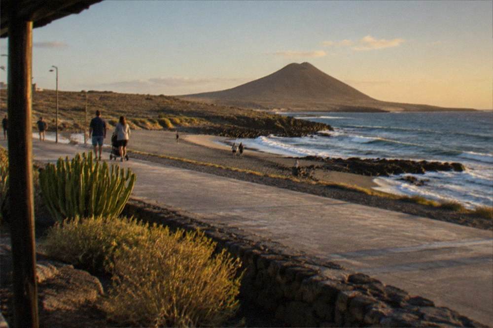 A quiet seaside promenade in Tenerife with a few strollers