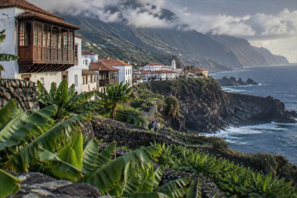 A coastal viewpoint in Tenerife with cliffs dropping to the sea in late afternoon light