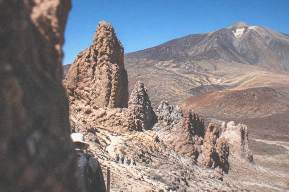 Red and grey volcanic rock formations at Roques de Garcia under a deep blue sky