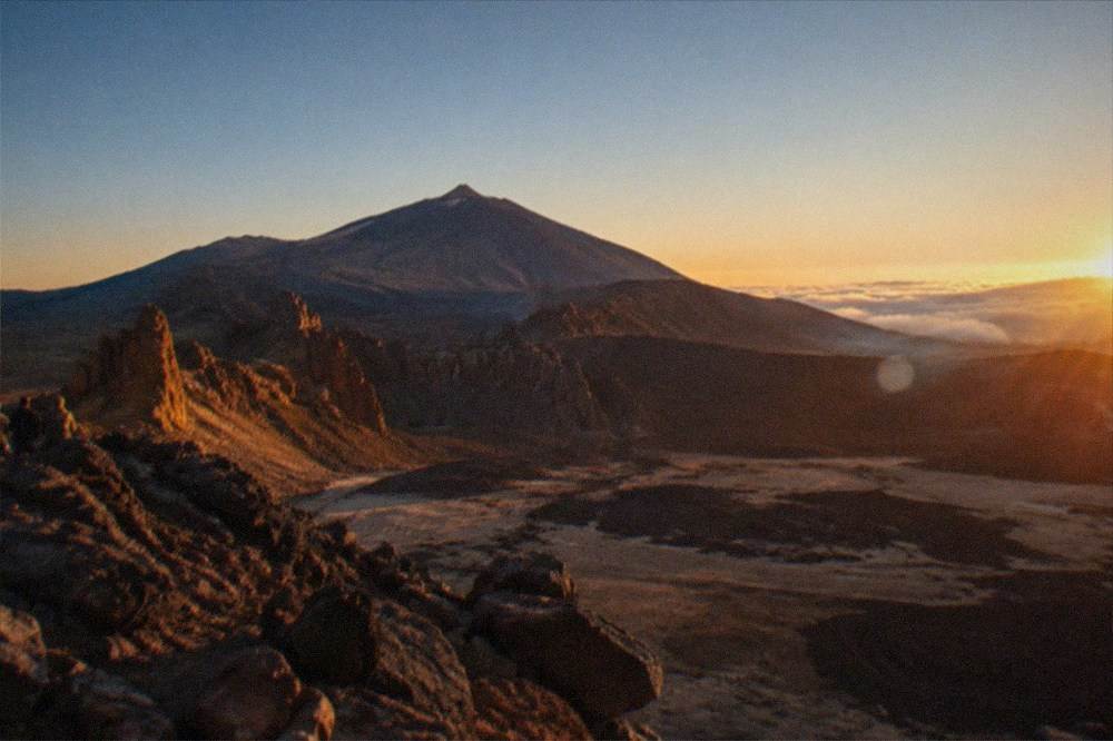 A viewpoint above the clouds looking towards Mount Teide's cone at sunset