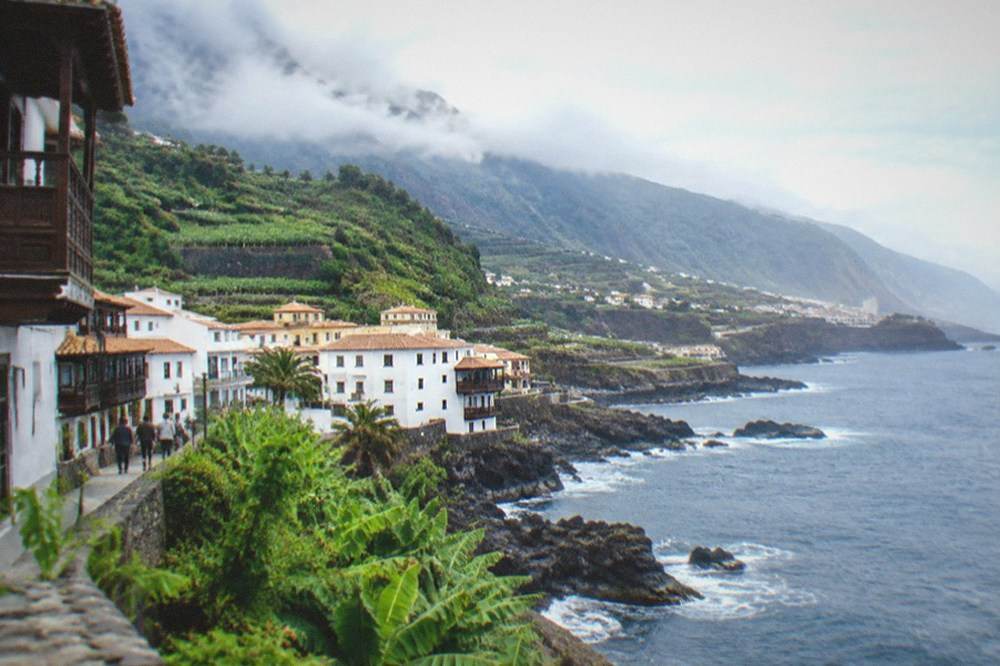 Clouds resting on green forested mountains in northern Tenerife