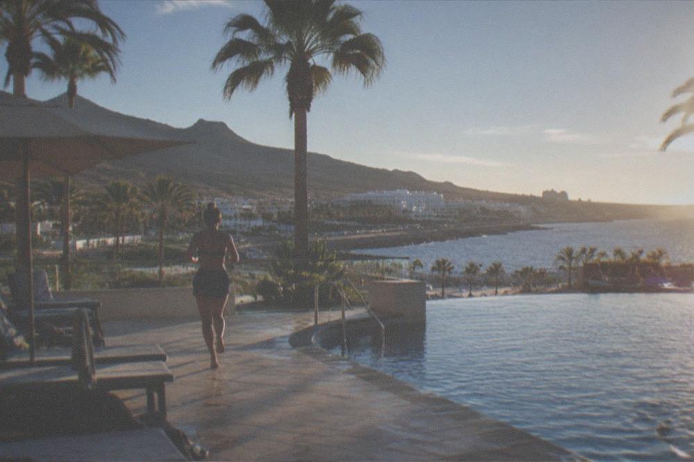 A hotel pool terrace with palm trees at Costa Adeje on the sunny southern coast