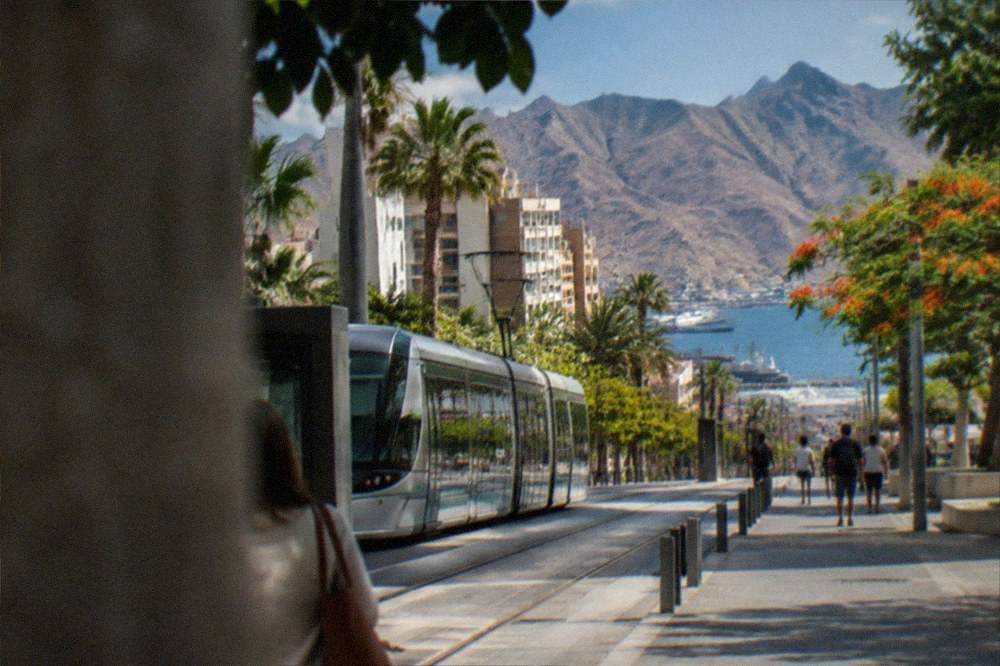 Tram and pedestrians on a sunny street in Santa Cruz de Tenerife