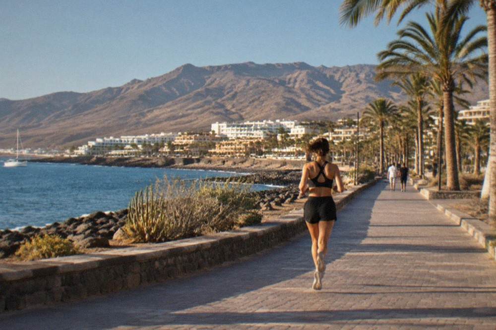 Palm-lined promenade in Costa Adeje under warm afternoon sun