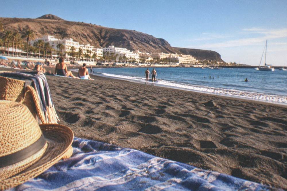 A busy but relaxed beach at Los Cristianos in warm winter sunshine