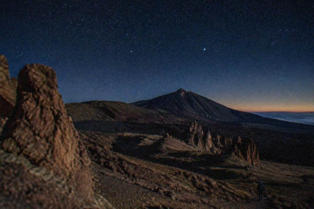 A clear starry night sky above the silhouette of Mount Teide