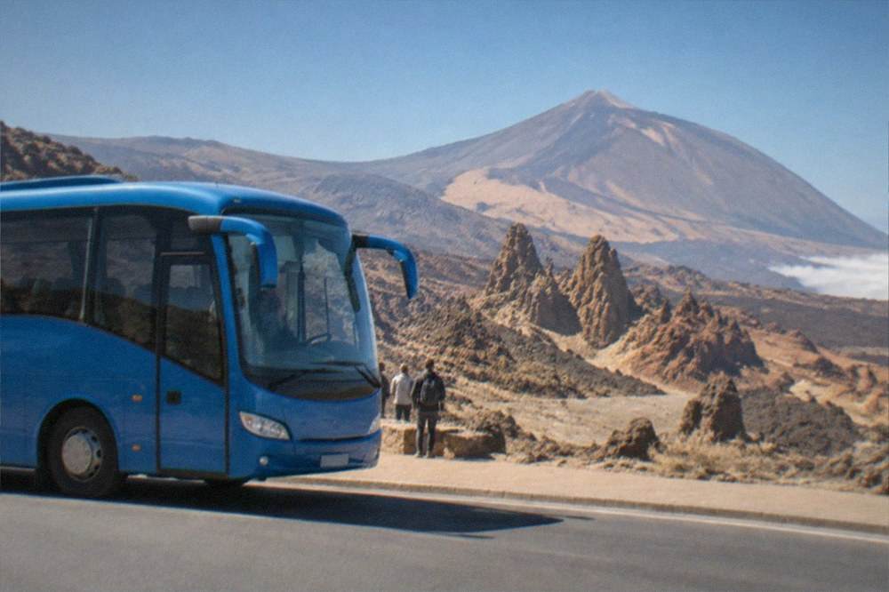 Blue island bus waiting at an airport kerb in sunshine