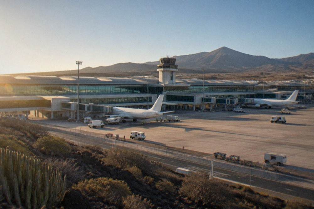 The terminal building of Tenerife South Airport under a clear blue sky