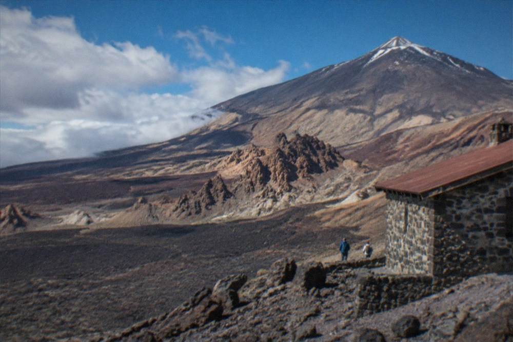 A stone refuge building on a volcanic slope high on Mount Teide