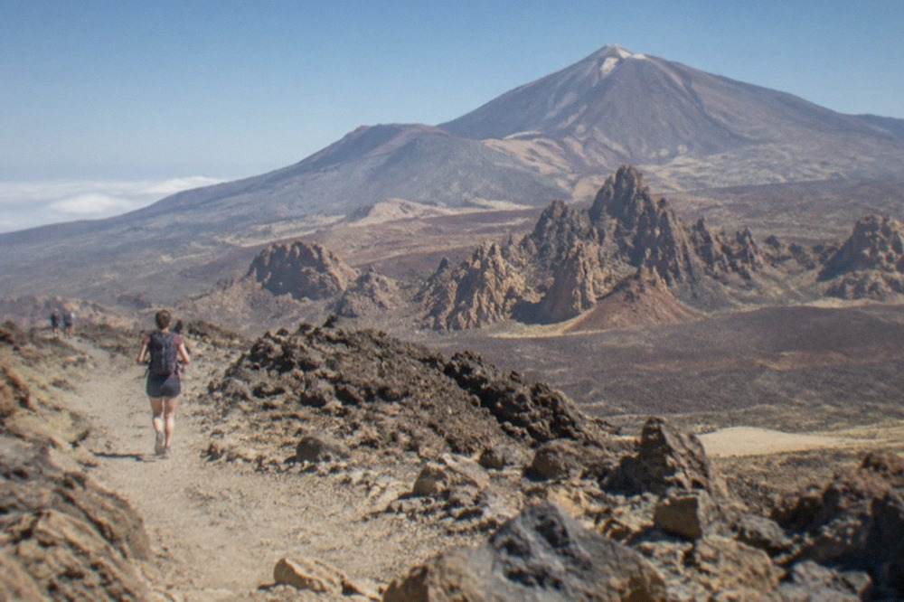 Mount Teide rising above a volcanic landscape under a clear blue sky