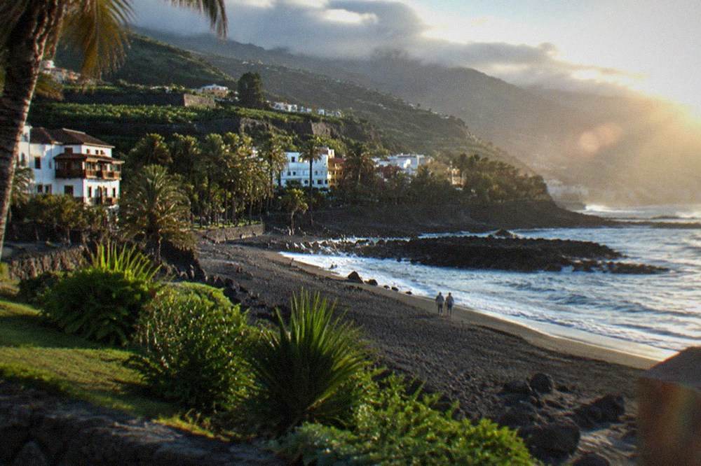 Black volcanic sand beach with palm gardens at Playa Jardin in Puerto de la Cruz