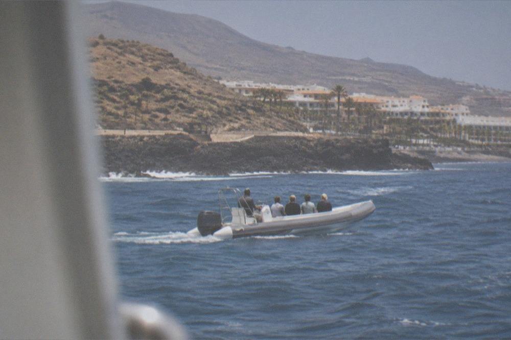 A small rigid inflatable eco boat with a handful of passengers sitting in a row