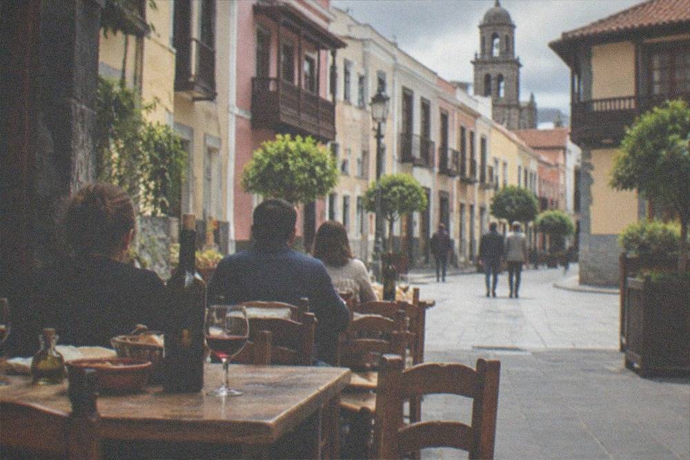 A rustic Canary Island country restaurant with wooden tables and bottles of local red wine