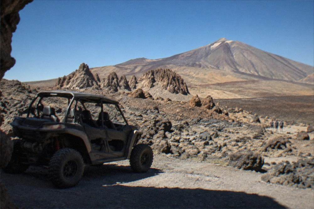 A buggy parked beside a lava field with the Teide summit in the distance
