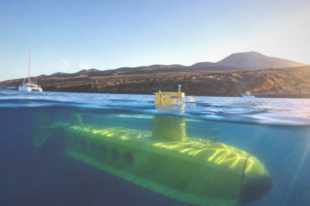 A yellow submarine seen through water with sunlight rays crossing the hull